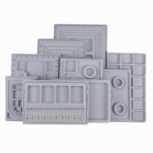May include: Set of nine gray plastic trays with various compartments and sizing guides for jewelry making.