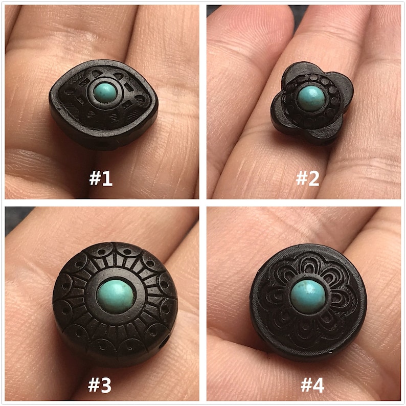 May include: Four black wooden beads with turquoise inlays. Each bead has a different design. #1 is an eye shape, #2 is a flower shape, #3 is a circle with a sunburst design, and #4 is a circle with a floral design.