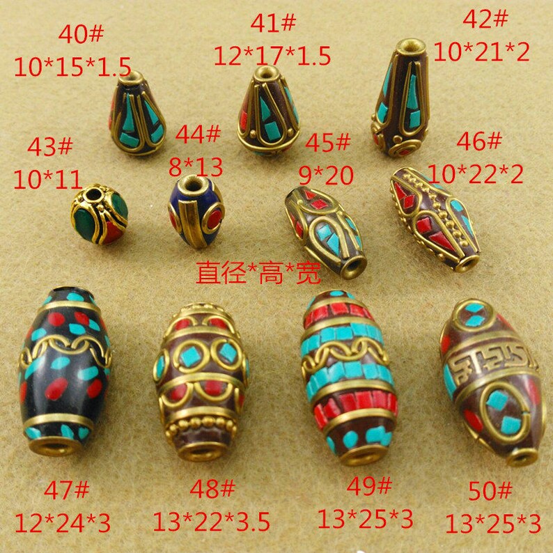 May include: Assortment of 10 Tibetan prayer beads made of brass and inlaid with turquoise, red, and black stones. The beads are oval and cone shaped. The beads are numbered 40 through 50 and have measurements in inches.