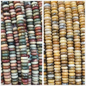 May include: Two strands of round, smooth, polished gemstone beads. One strand is made of multi-colored jasper beads, the other is made of light brown and beige jasper beads.