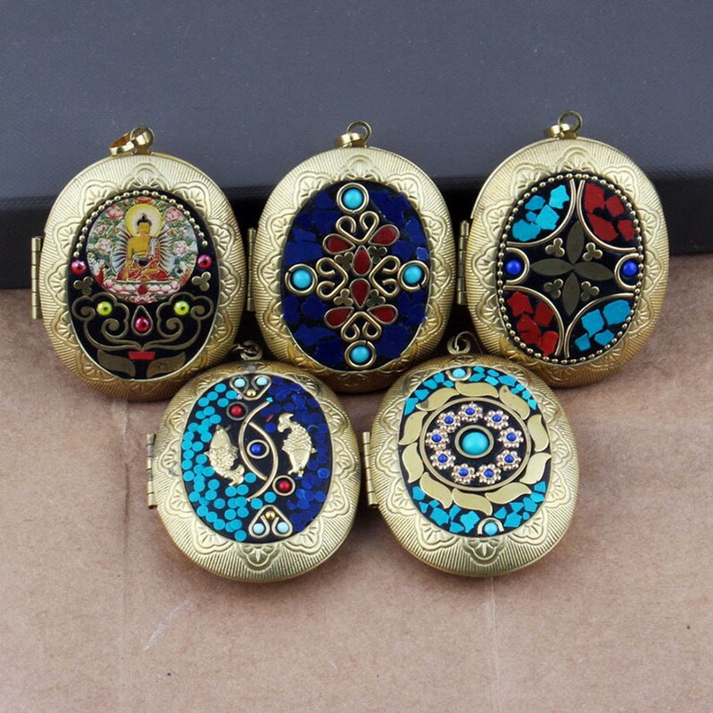 May include: Five oval-shaped brass locket pendants with intricate designs. Each locket features a different colorful mosaic pattern with blue, red, and green accents. The lockets are perfect for adding a touch of vintage charm to any jewelry collection.