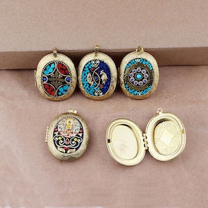 May include: Five oval-shaped locket pendants with intricate designs. The lockets are made of brass and feature a variety of colorful mosaic patterns, including blue, red, and gold. Some lockets have a hinged opening.