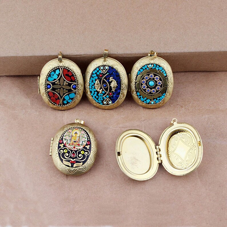 May include: Five oval-shaped locket pendants with intricate designs. The lockets are made of brass and feature a variety of colorful mosaic patterns, including blue, red, and gold. Some lockets have a hinged opening.