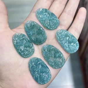 May include: Six oval-shaped green and blue agate cabochons with a swirling pattern. The cabochons are smooth and polished.
