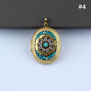 May include: Gold oval locket pendant with a blue and turquoise mosaic design. The center of the locket features a blue stone surrounded by smaller turquoise stones.
