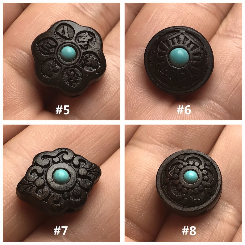 May include: Four black wooden beads with intricate carvings and turquoise accents. Each bead features a different design, including a flower, a circle, and two diamond shapes.