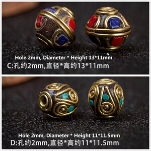 May include: Two sets of round, brown beads with gold trim and colorful accents. The beads are approximately 13 mm in diameter and 11 mm in height. The beads have a hole in the center for stringing.