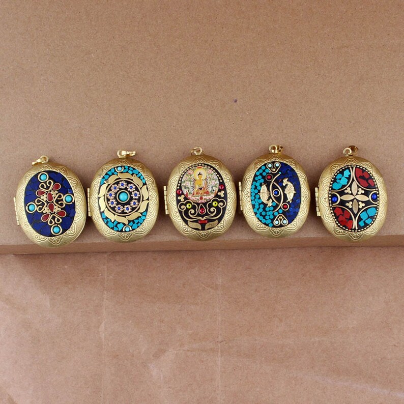 May include: Five oval-shaped brass locket pendants with intricate designs. Each locket features a different colorful mosaic pattern with turquoise, red, blue, and gold accents.