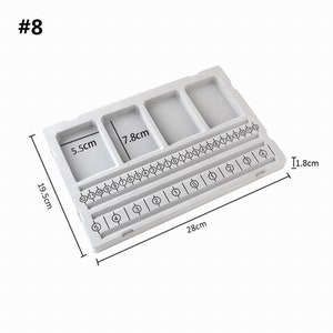 May include: A white plastic ring sizing tool with five compartments and a numbered sizing guide. The tool measures 19.5 inches long, 7.8 inches wide, and 1.8 inches tall.