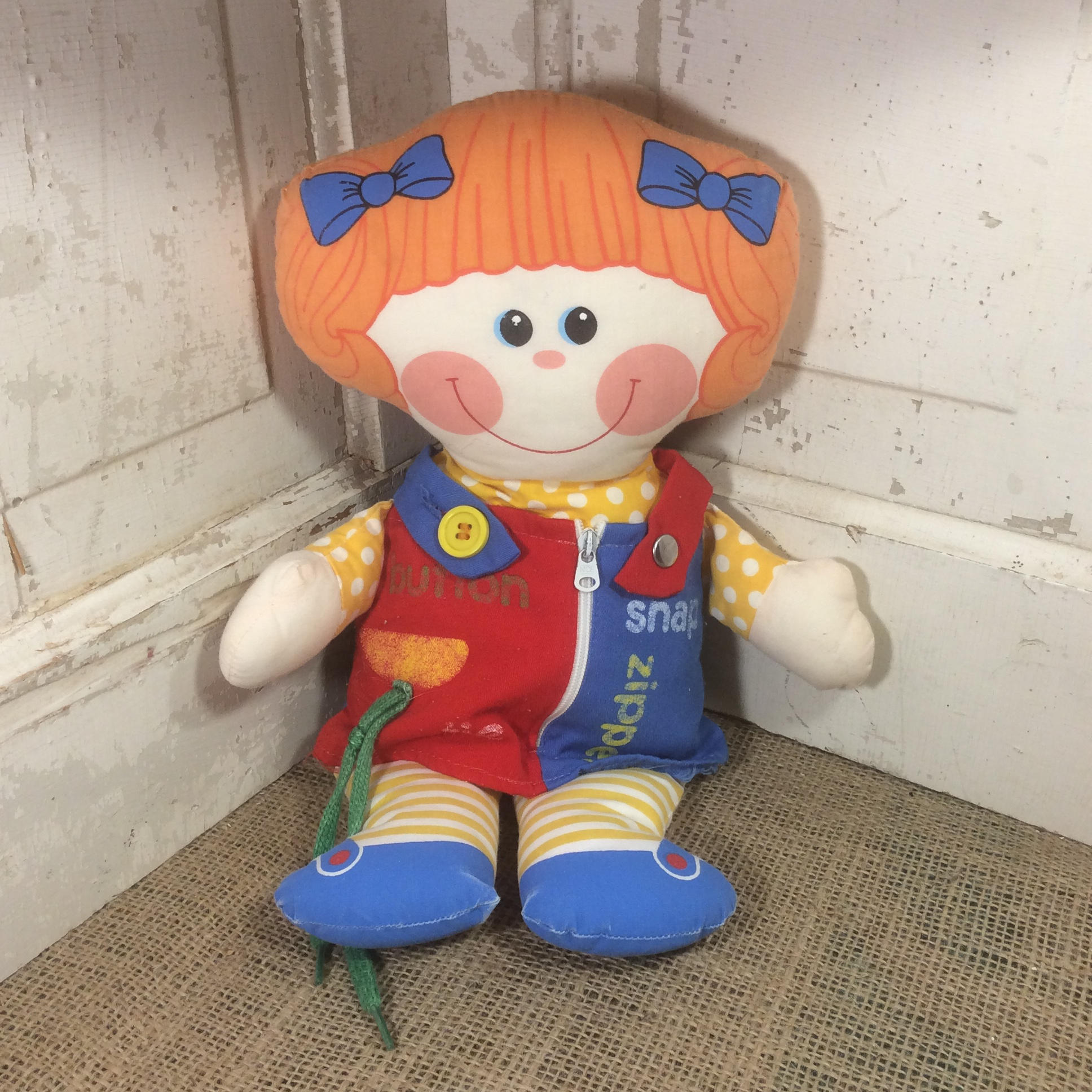 learning doll with zips and buttons