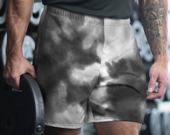 May include: Athletic shorts with a cloud-like pattern in shades of gray and white. The shorts are designed for workouts and feature a comfortable fit. The image shows the shorts on a person in a gym setting, with weights in the background.