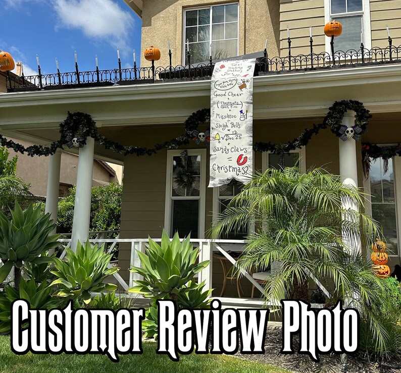 May include: A house decorated for Halloween and Christmas. A banner with the text "Good Cheer", "Mistletoe", "Sleigh Bells", "Dec 25", and "Sandy Claws = Christmas?" hangs from the roof. The house has pumpkins and Halloween decorations.