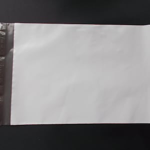 May include: A white poly mailer envelope with a self-sealing adhesive strip on the left side. The envelope is rectangular and has a smooth surface. The background is black.