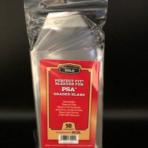 May include: A clear plastic bag containing 50 "Perfect Fit" sleeves for PSA graded slabs. The red and gold label indicates the sleeves are resealable, acid-free, and made of 2 Mil OPP material. The bag has a hole for hanging.