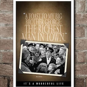 May include: A framed black and white photograph from the movie "It's a Wonderful Life" with the quote "A toast to my big brother George: the richest man in town." The photograph shows a group of people.