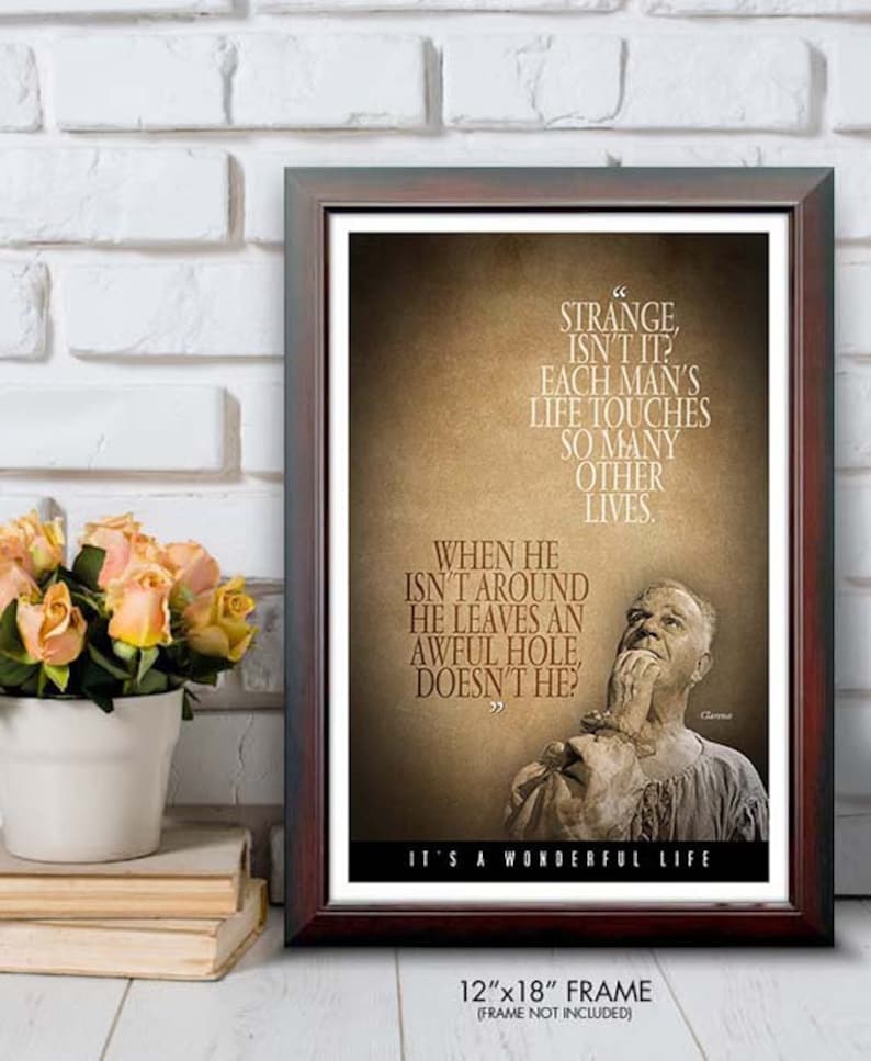 May include: Framed print with a quote from "It's a Wonderful Life." The text is in a brown font on a tan background, with a portrait of a man. The frame is dark brown, and the print is 12"x18".
