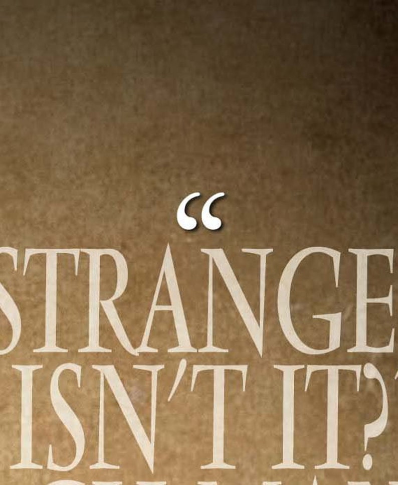 May include: A brown background with the words "STRANGE ISN'T IT?" in a cream-colored font. Above the word "STRANGE" are white quotation marks.