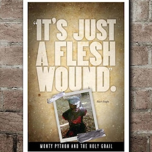 May include: A poster with the quote "IT'S JUST A FLESH WOUND." in large white letters. A photo of a knight in armor is taped to the poster. The text "MONTY PYTHON AND THE HOLY GRAIL" is at the bottom.