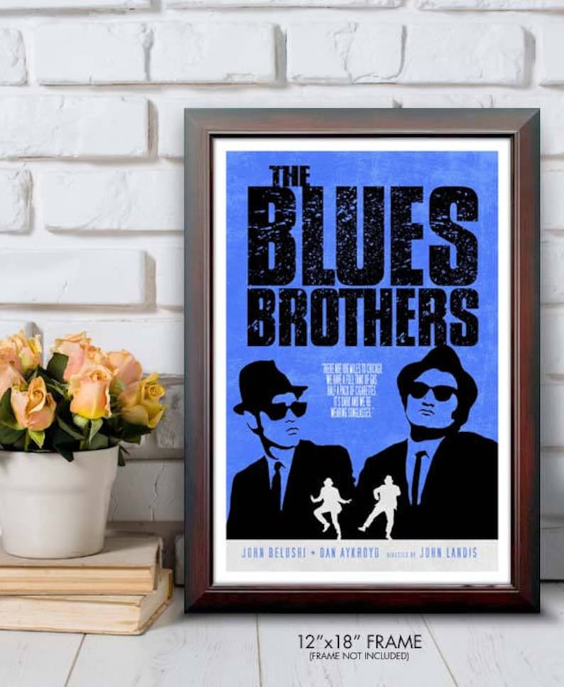 May include: Framed poster for "The Blues Brothers" movie. The poster features a blue background with the film's title in large black letters. Silhouettes of the two main characters are visible. The frame is 12"x18".