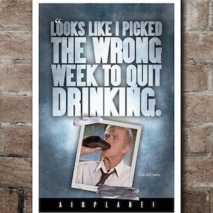 May include: A poster with the quote "Looks like I picked the wrong week to quit drinking." The poster features a photo of a man drinking from a bottle. The word "AIRPLANE!" is at the bottom.
