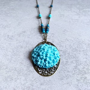 Blue Hydrangea Beaded Necklace - Antique Bronze Filigree Oval Pendant, Resin Flower Cabochon, Matte Navy Blue Beads, Turquoise Beads, Boho