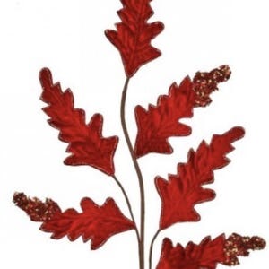 May include: A decorative stem featuring vibrant red fabric leaves with a glittery gold trim. The leaves are arranged along a brown stem, creating a festive and eye-catching design. Perfect for fall or holiday decor.