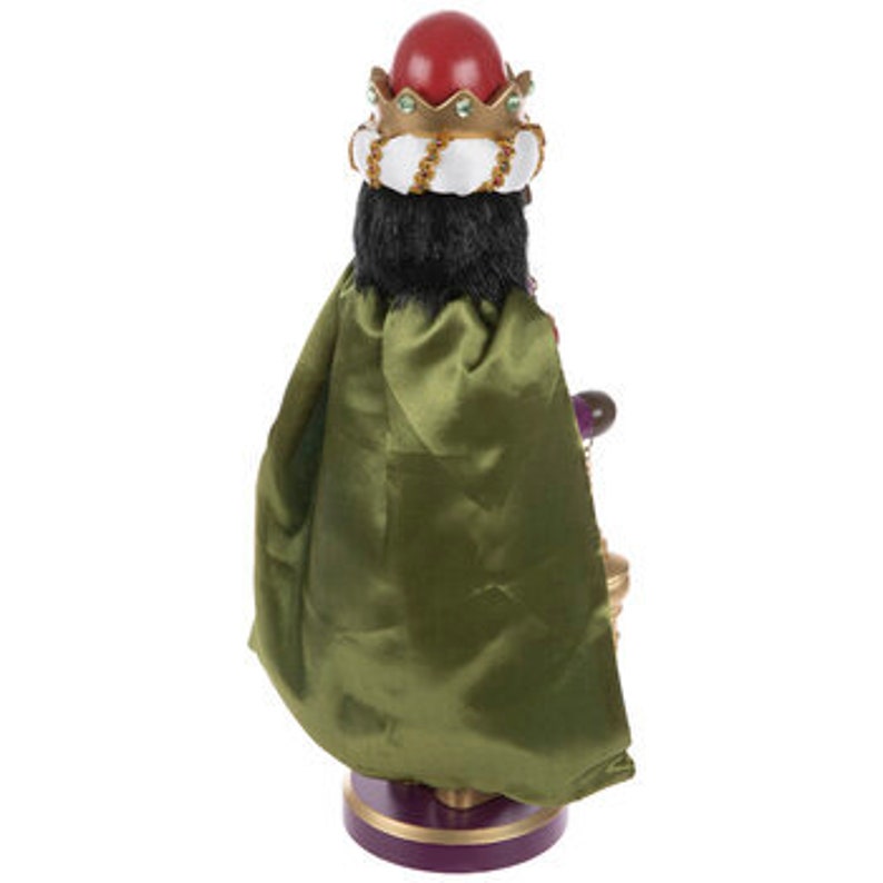 May include: A decorative figurine of a king, featuring a red crown, black hair, and a green cape. The figurine has a gold-colored base and holds a golden chalice. The figure is approximately 12 inches tall.