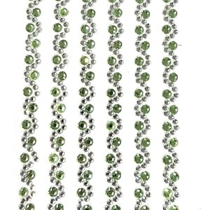 May include: Five rows of green and silver rhinestones arranged in a zig-zag pattern. The rhinestones are small and round.