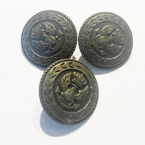 Vintage metal buttons with coat of arms design and decorative border