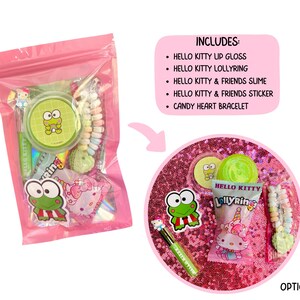May include: A pink cellophane bag filled with Hello Kitty themed items. Includes lip gloss, a lollipop ring, slime, a sticker, and a candy heart bracelet. The bag also contains a Keroppi sticker and a Keroppi compact.