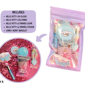 May include: A clear, lavender-colored bag filled with Hello Kitty-themed items. Includes lip gloss, a lolly ring, slime, a sticker, and a candy heart bracelet. The bag is sealed and contains a variety of pink and blue items, with the text "HELLO KITTY" visible.