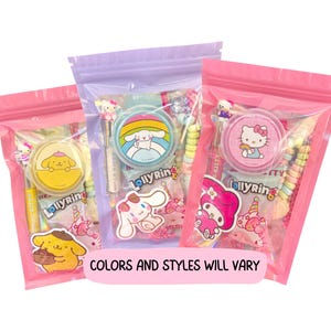 May include: Three pink, purple, and pink zip-lock bags filled with candy and character-themed accessories. Each bag features a different character, including Hello Kitty, My Melody, and Cinnamoroll. The text "COLORS AND STYLES WILL VARY" is displayed on a pink banner.