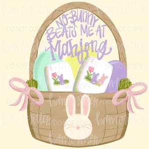 May include: An Easter-themed illustration of a woven basket filled with Mahjong tiles and decorative elements. The basket features a bunny face and pink bows. The text "NO-BUNNY BEATS ME AT Mahjong" is written above the tiles.