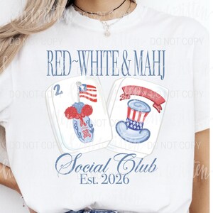 May include: White t-shirt with a patriotic design. The shirt features the text "RED~WHITE & MAHJ" above two illustrated Mahjong tiles. One tile has an American flag, the other a Uncle Sam hat. Below is "Social Club Est. 2026".