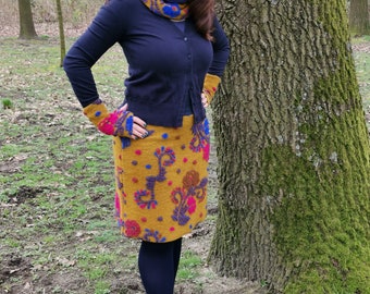 Ladies' skirt made of felted cloth in ochre yellow and colourful tendrils. Cuffs in dark blue. Available in all plus sizes.