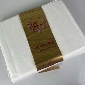 May include: A white sheet with a gold label that says "Dan River 1882" and "Dancale Combed Percale".