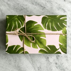 All occasion gift wrap, large green monstera leaves on a blush-pink background. Fine flat sheet wrapping paper.