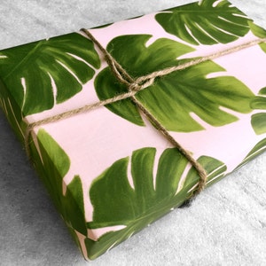 All occasion gift wrap, large green monstera leaves on a blush-pink background. Fine flat sheet wrapping paper.