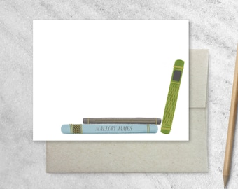 May include: A white card with a stack of three books on the bottom. The top book is green with gold accents. The middle book is gray with gold accents. The bottom book is light blue with gold accents. The text "Mallory James" is printed on the bottom book.