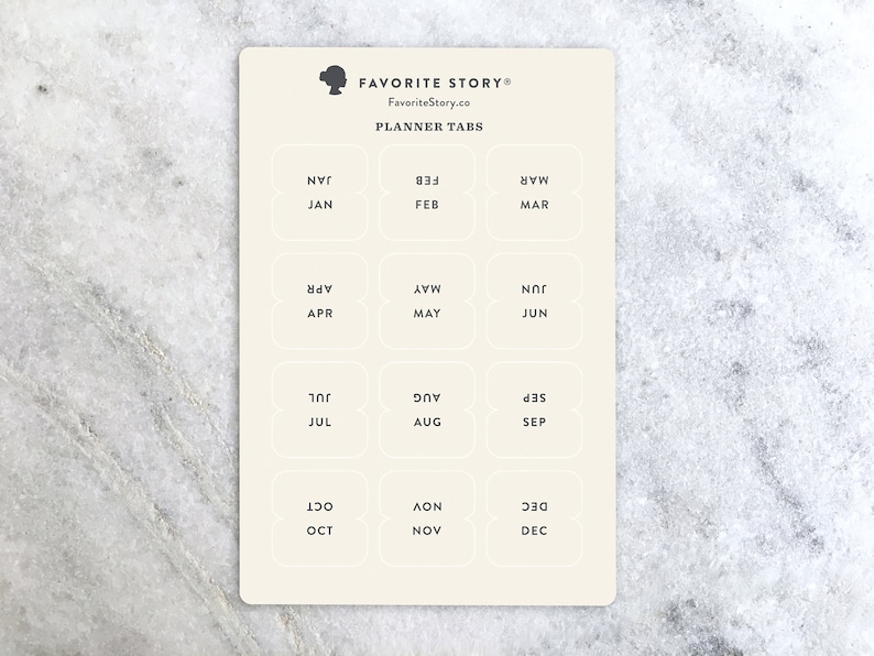 May include: A cream-colored planner tab sheet with the text "FAVORITE STORY" and "PLANNER TABS". Each tab is labeled with a month of the year, such as JAN, FEB, MAR, APR, MAY, JUN, JUL, AUG, SEP, OCT, NOV, and DEC.