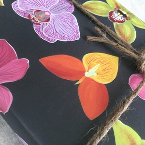 All occasion gift wrap, boldly colored orchid illustrations on a black background. Fine flat sheet wrapping paper.