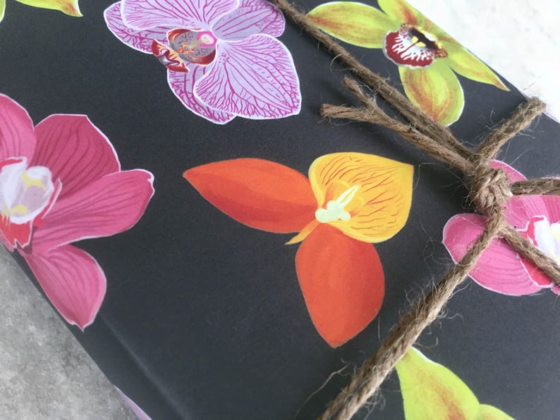 All occasion gift wrap, boldly colored orchid illustrations on a black background. Fine flat sheet wrapping paper.