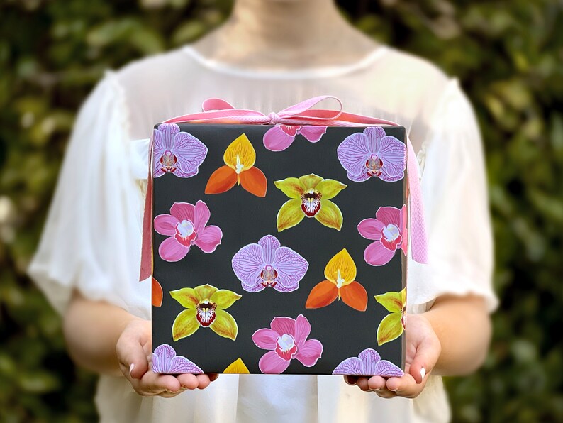 All occasion gift wrap, boldly colored orchid illustrations on a black background. Fine flat sheet wrapping paper.