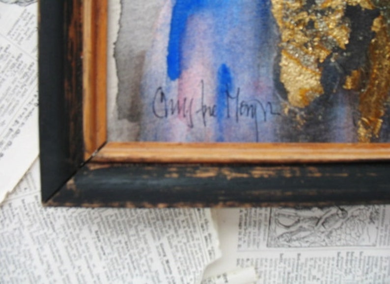 May include: A framed watercolor painting with a blue and pink background. The painting is signed "Chris the Monkey".