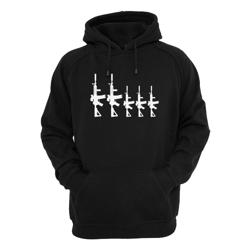 May include: Black hooded sweatshirt with a white graphic of five rifles in a row. The sweatshirt has a drawstring hood and a front kangaroo pocket. The graphic is centered on the chest.