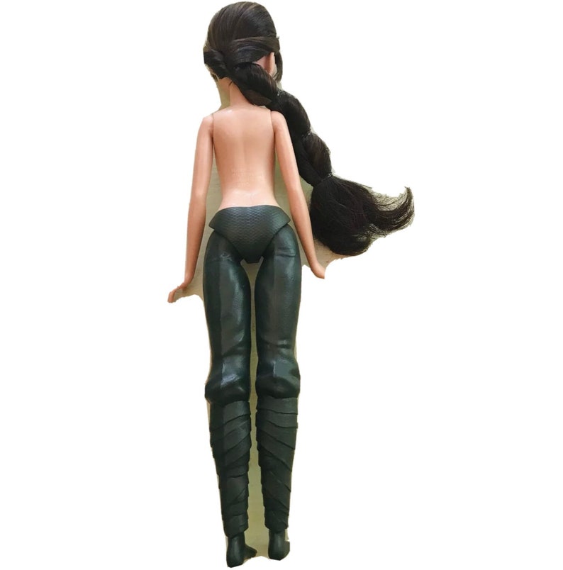 May include: A black doll with long black hair styled in a braid. The doll is wearing black trousers and boots.