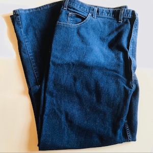 May include: A pair of dark blue denim jeans. The jeans have a classic five-pocket style and a straight leg.