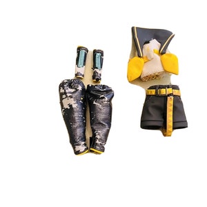 May include: A set of black and white patterned pants with yellow trim, a black and yellow belt, and a black and yellow top with a white collar and yellow trim.