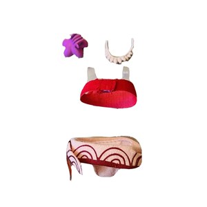 May include: A doll outfit with a red top, a white and brown skirt, a purple flower, and a white headband.