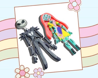 May include: Black and white Jack Skellington and green and yellow Sally from The Nightmare Before Christmas as articulated plastic figures.